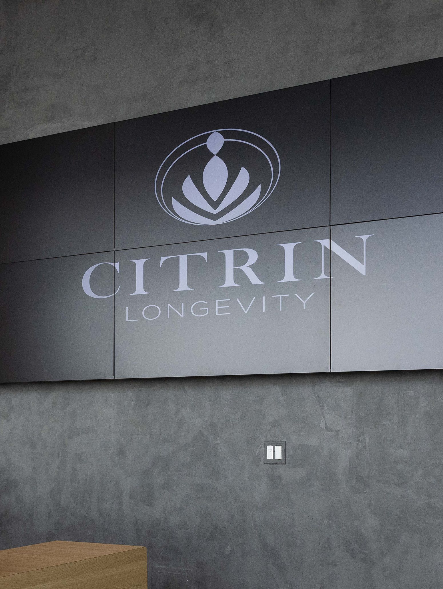 The Citrin Longevity logo on the display wall above reception at the West Hollywood clinic in Los Angeles