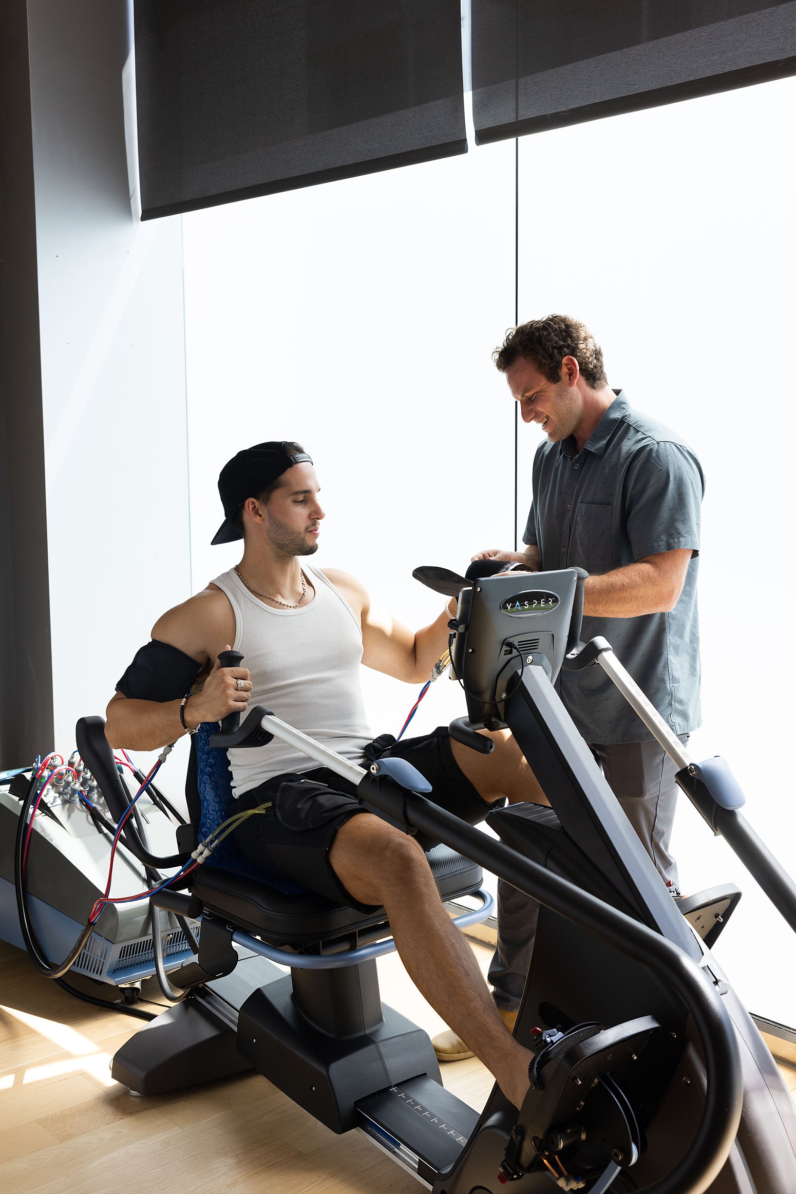 A coach guiding a member through a VASPER session at Citrin Longevity in West Hollywood, the machine volume in the Performance membership
